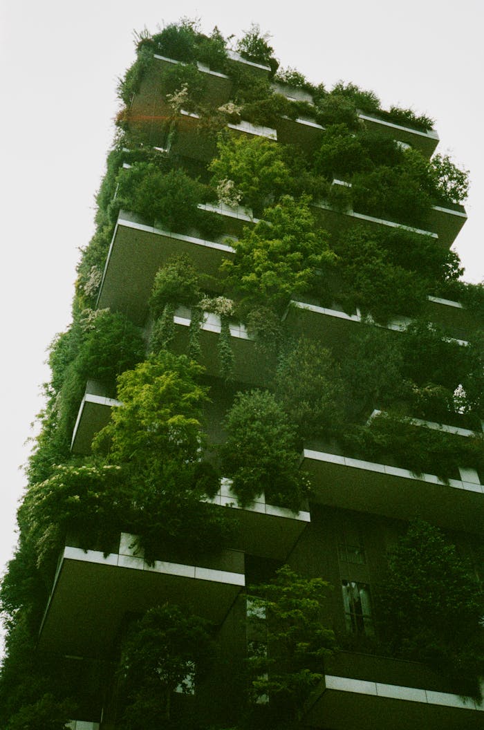 A striking vertical forest building in Milan featuring abundant greenery and plants on the facade.